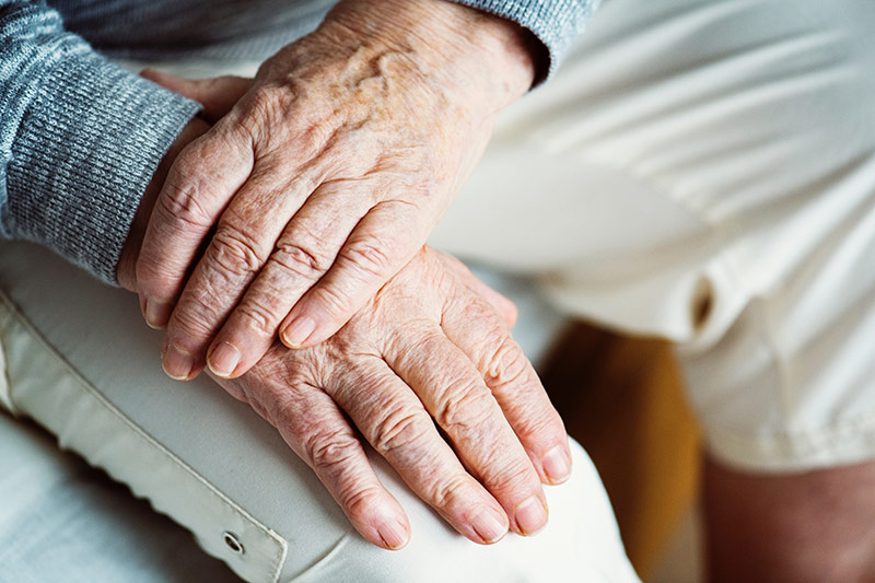 Senior resting his left hand on his right hand