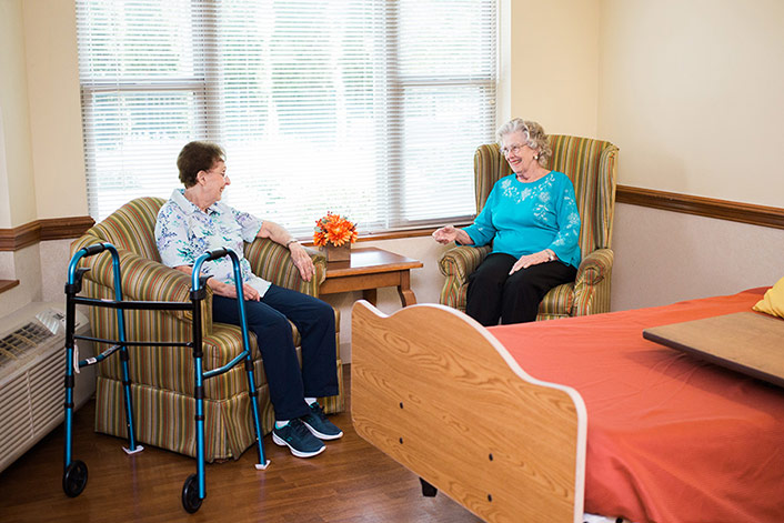 Two residents sitting down having a discussion