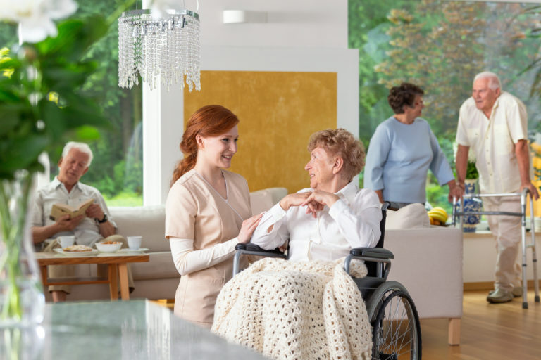 A nurse assisting a resident at an assisted living community with skilled nursing.