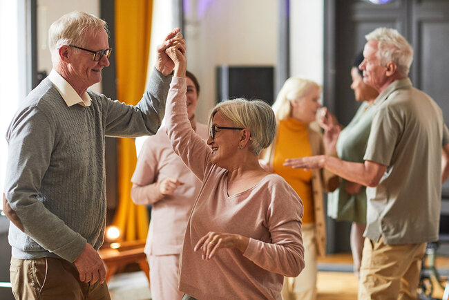 Pair of active seniors taking dance lessons together