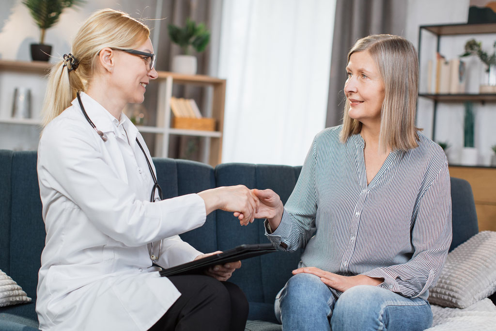 Senior-aged woman discussing long-term care insurance with a skilled nursing facilitator