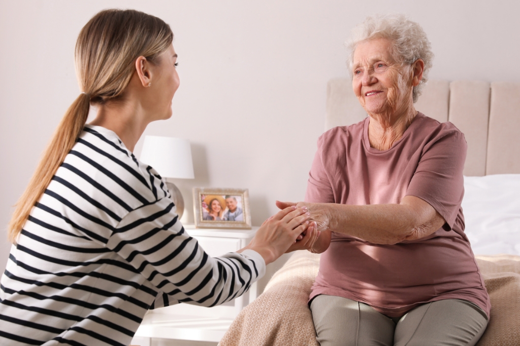 An adult daughter talking to his aging parent about moving to an assisted living or senior care facility.