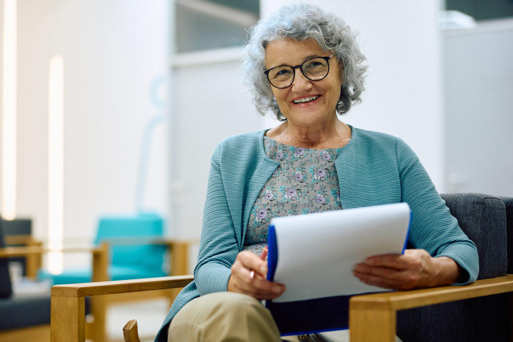 Senior filling out paperwork for senior living facility admission.